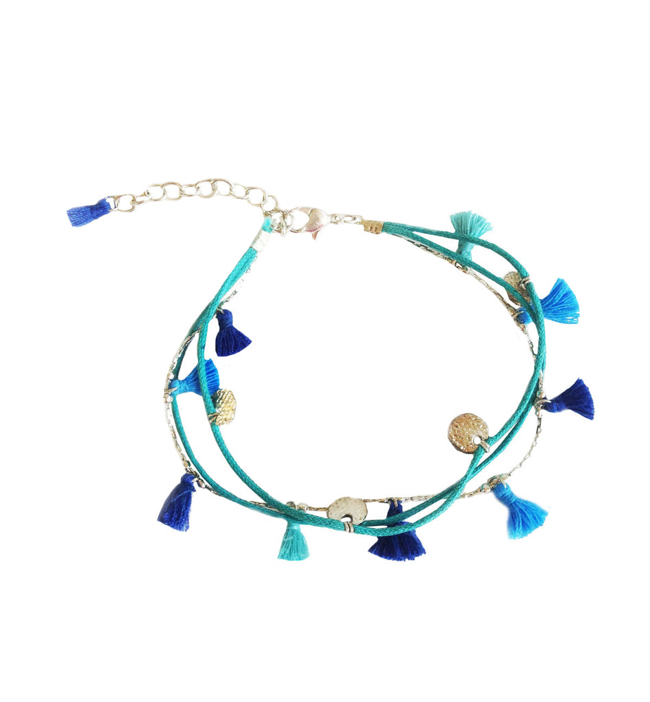 Blue bracelet with tassels and coin pendant detailing