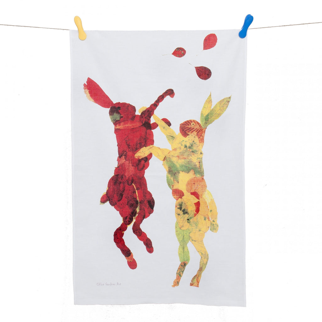 Hares jumping on white tea towel